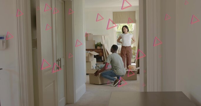 Unpacking two adults wearing white top and gray tee, placing moving boxes in hallway, pink overlays - Powered by Adobe