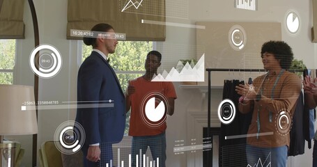 Presenting suited man leading five men group in showroom, showing clothing rack with AR overlays