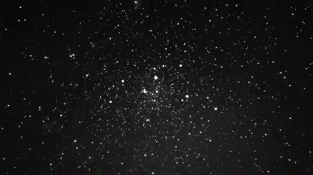 Dense globular star cluster in a field of stars against a dark night sky.