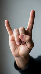 Hand gesture symbolizing rock and roll music culture.