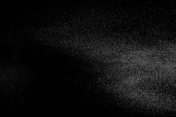The falling white snow on a black background