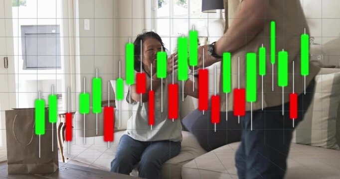 Woman sitting on sofa smiling, man entering handing glasses, toasting with finance chart overlay