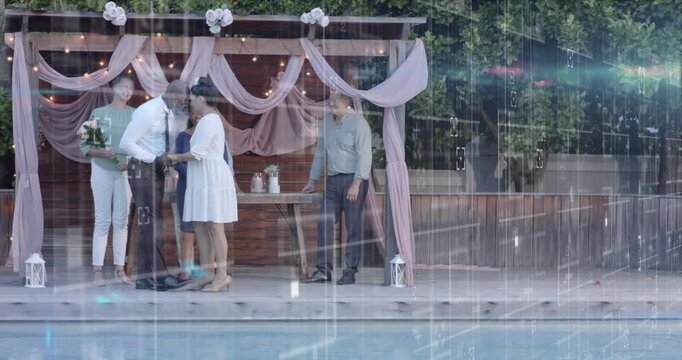 Wedding groom placing ring, couple kissing, sealing vows on poolside pergola, overlays crossing