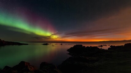 Aurora borealis in green and pink arches across the night sky over a rocky shoreline, reflected in the calm water. - Powered by Adobe