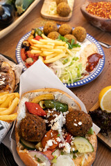 Falafel pita sandwich with french fries and salad