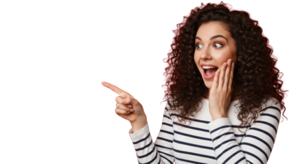 Young caucasian woman, early 20s, dark brown curly hair, striped shirt, shocked and excited, pointing left, against vibrant red studio background with copy space. Concept of exciting announcement and