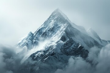 Stunning snow capped mountain peak rising above the clouds, creating a breathtaking view of nature's grandeur