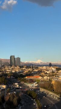 Damavand mountain view volcanic range over Tehran urban cityscape panoramic landscape with stunning skyline winter snow morning sunrise breathtaking metropolitan lifestyle travel Persia architecture
