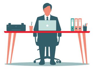 A businessman sits at his desk working on a laptop in an office.