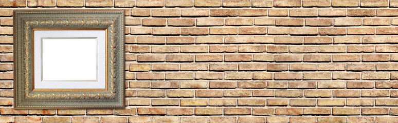 Horizontal banner with blank picture frame with passe-partout, hanging on brick wall. Empty Vintage gilded wood photo frame with carved decorative border on wall background. Copy space for text