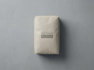 Artisan flour packaging displayed on a textured gray surface, showcasing the minimalist design and natural materials, ideal for culinary and baking projects with a modern aesthetic