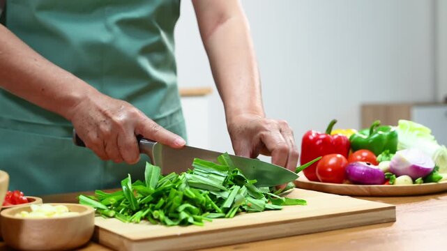 Fresh vegetables being chopped for a healthy meal, showcasing culinary skills and home cooking with kitchen tools and organic ingredients for delicious, healthy recipes.