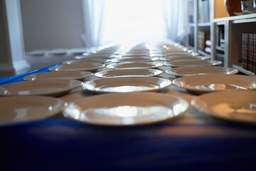 Table, setup and arranged plates at house for dining, food preparation and event planning....