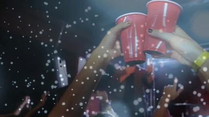 Singer singing music under lights, camera pushing crowd, hands raising red cups clinking toasting