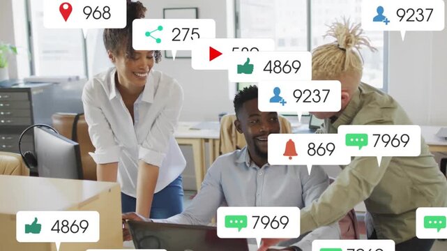 Team opening laptop, watching icons multiplying across screen and hiding desk, discussing marketing