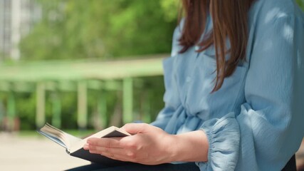 lady reading outside, serene woman enjoying sunny reading, peaceful female relaxes with book outdoors in sunlight, tranquil lady engages in quiet book study amidst bright outdoor sunlight surroundings