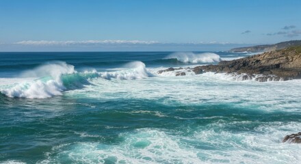 Fototapeta premium Powerful ocean waves crashing against a rocky coastline under a vibrant blue sky