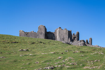 The ruin of Carreg Cennen Castle sited on a high rocky outcrop in Carmarthenshire, Wales on a sunny day