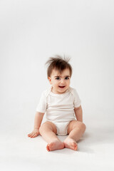cute baby on a white isolated background, space for text, baby boy in a white bodysuit smiling