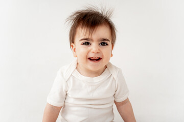 cute baby on a white isolated background, space for text, baby boy in a white bodysuit smiling