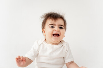 cute baby on a white isolated background, space for text, baby boy in a white bodysuit smiling