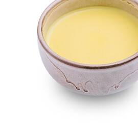 Warm yellow soup served in a rustic bowl with simple design