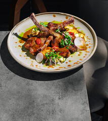 Delicious gourmet lamb dish served on a stylish plate at a modern restaurant