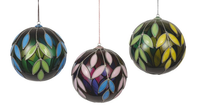 Three decorative stained glass orbs with leaf patterns hanging on white background sphere