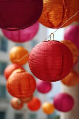 Vibrant red and orange paper lanterns hanging outdoors at festival