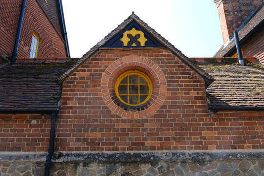 Circular Yellow Window and Decorative Pattern on Red Brick Gothic Revival Architecture, St Annes Hill, Midhurst