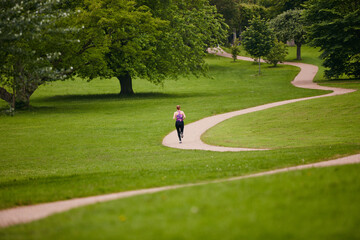 Running, back and woman in park, exercise and challenge with fitness, endurance or morning routine....