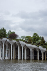 Fototapeta premium Modern Floating Park Over Water. Little Island, NYC. modern architectural pier by the water, a stunning photo capturing a modern architectural pier with unique, sculptural columns