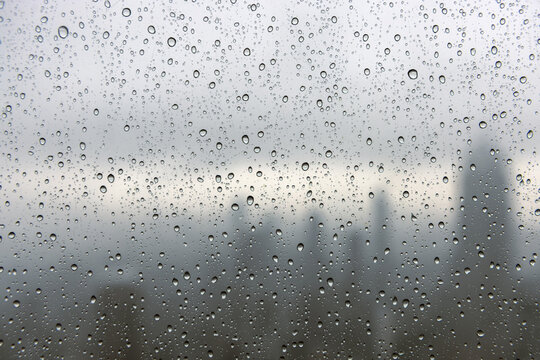 Raindrops on Window with City Skyline in Background. Manhattan, NYC - Powered by Adobe