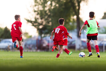 Kids soccer football - children players match on soccer field