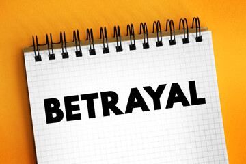 Betrayal - the action of betraying one's country or a person, treachery, text concept on notepad