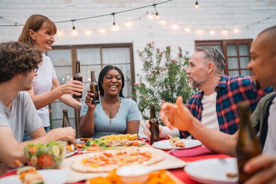 Warm family atmosphere shines through outdoor gathering, laughter, shared meals, joyful conversations, bonding moments, happiness comfort, connection and cherished memories create lasting togetherness