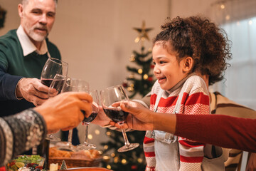 Family and friends raise their glasses to celebrate a joyful evening filled with laughter wine delicious food and the warmth of togetherness during a special festive gathering