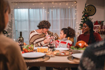 joyful family sharing a warm festive Christmas dinner creating happy memories together with laughter delicious food, spirit of love celebration togetherness around the holiday table