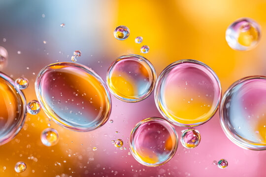 Colorful water droplets suspended in air creating a vibrant abstract background with bubbles