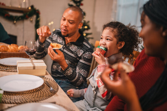 joyful family sharing a warm festive Christmas dinner creating happy memories together with laughter delicious food, spirit of love celebration togetherness around the holiday table - Powered by Adobe