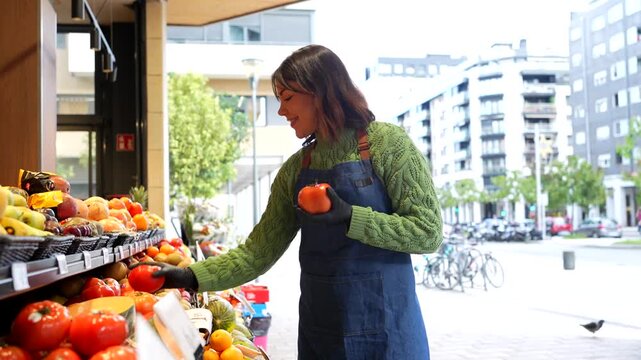 Greengrocer organizing fresh organic produce at an outdoor market stall - Powered by Adobe