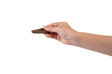 Chocolate bar in hand on transparent background