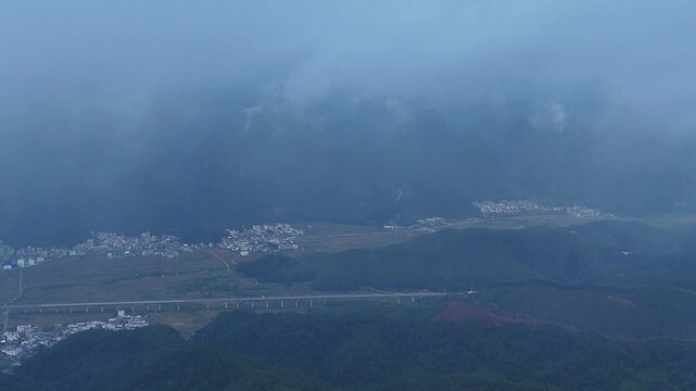 Modern Rail Through Ancient Karst Landscape in Morning Fog 