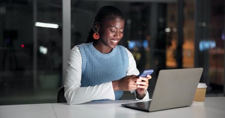Happy, black woman or night with laptop or phone for social media, network or chatting in office. Female person, typing or texting with mobile smartphone or computer in late evening for communication - Powered by Adobe