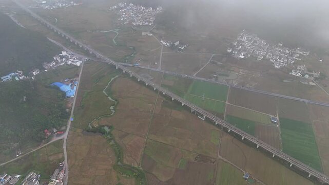Aerial View of Railway Through Misty Karst Landscape at Dawn