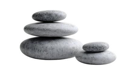 Stack of smooth gray stones balanced on each other against a dark black studio background scene view