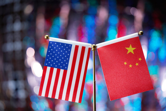 American and Chinese flag pair against bokeh light as background