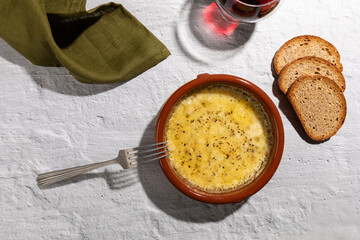 Provolone cheese baked in oven seasoned with oregano, argentinian provoleta.