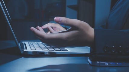 A man's hands are busy typing on a laptop keyboard during the nighttime, engaged in work, business development, studying, and playing computer games - Powered by Adobe