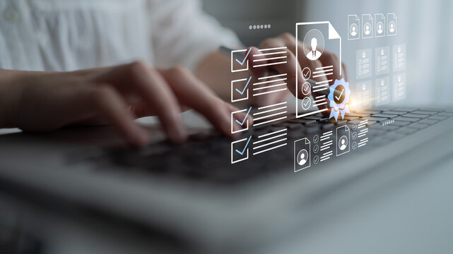 Close-up of hands typing on a laptop keyboard with a digital overlay showing checklists and user profile icons, symbolizing online assessment and productivity in a modern workspace. Gantry - Powered by Adobe